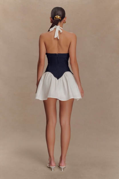 Back view of navy corset mini dress with white halter ties and full skirt