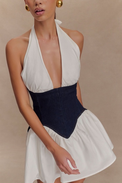 Close-up of halter neckline and navy denim corset bodice with stitching detail