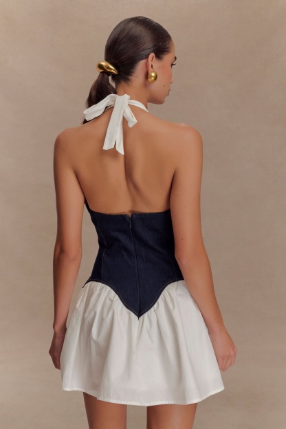 Back detail of navy denim corset with center seam and white tie closure