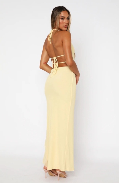 Back view of cream maxi dress with lace-up cutout detail and long train