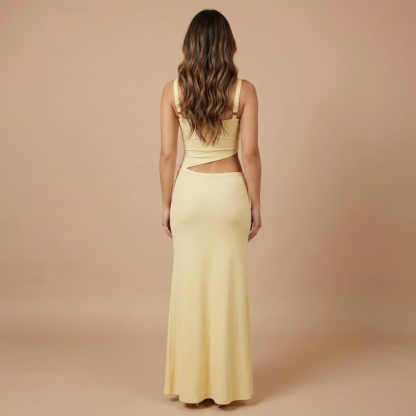 Back view of pale yellow cutout maxi dress with square neckline and waist opening