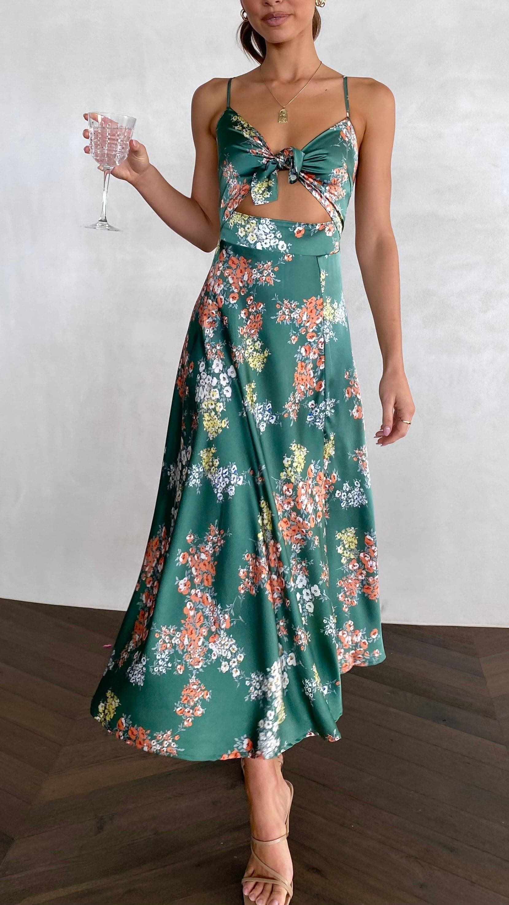 Front view of green midi dress with multicolor floral print and cutout waist