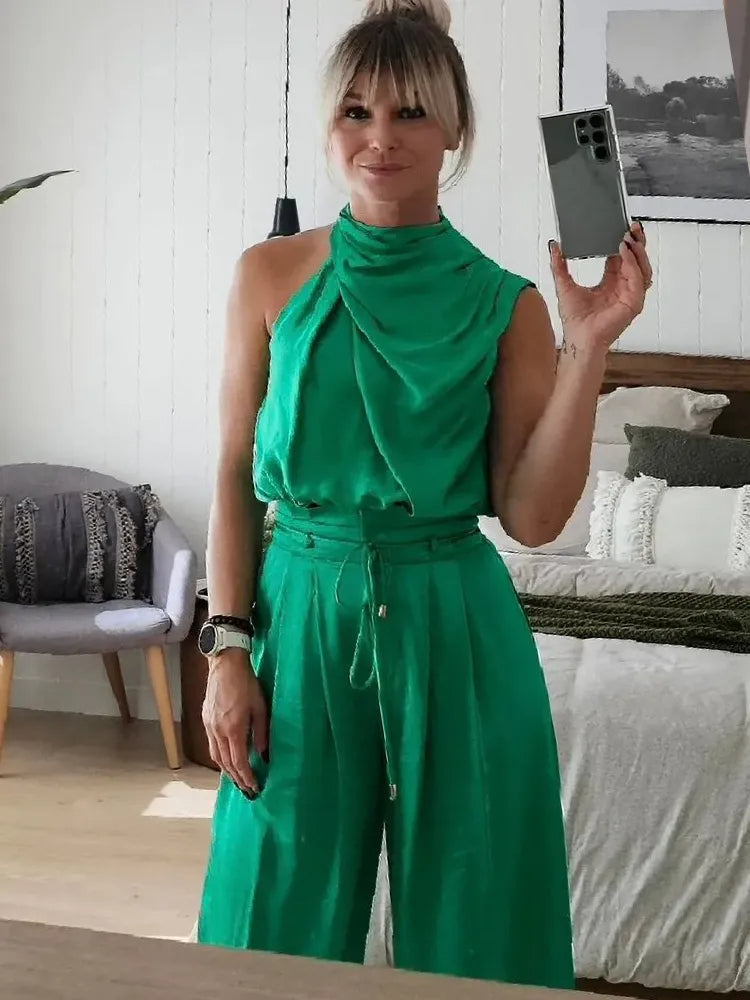 Emerald green draped sleeveless top with matching wide-leg pants and drawstring waist