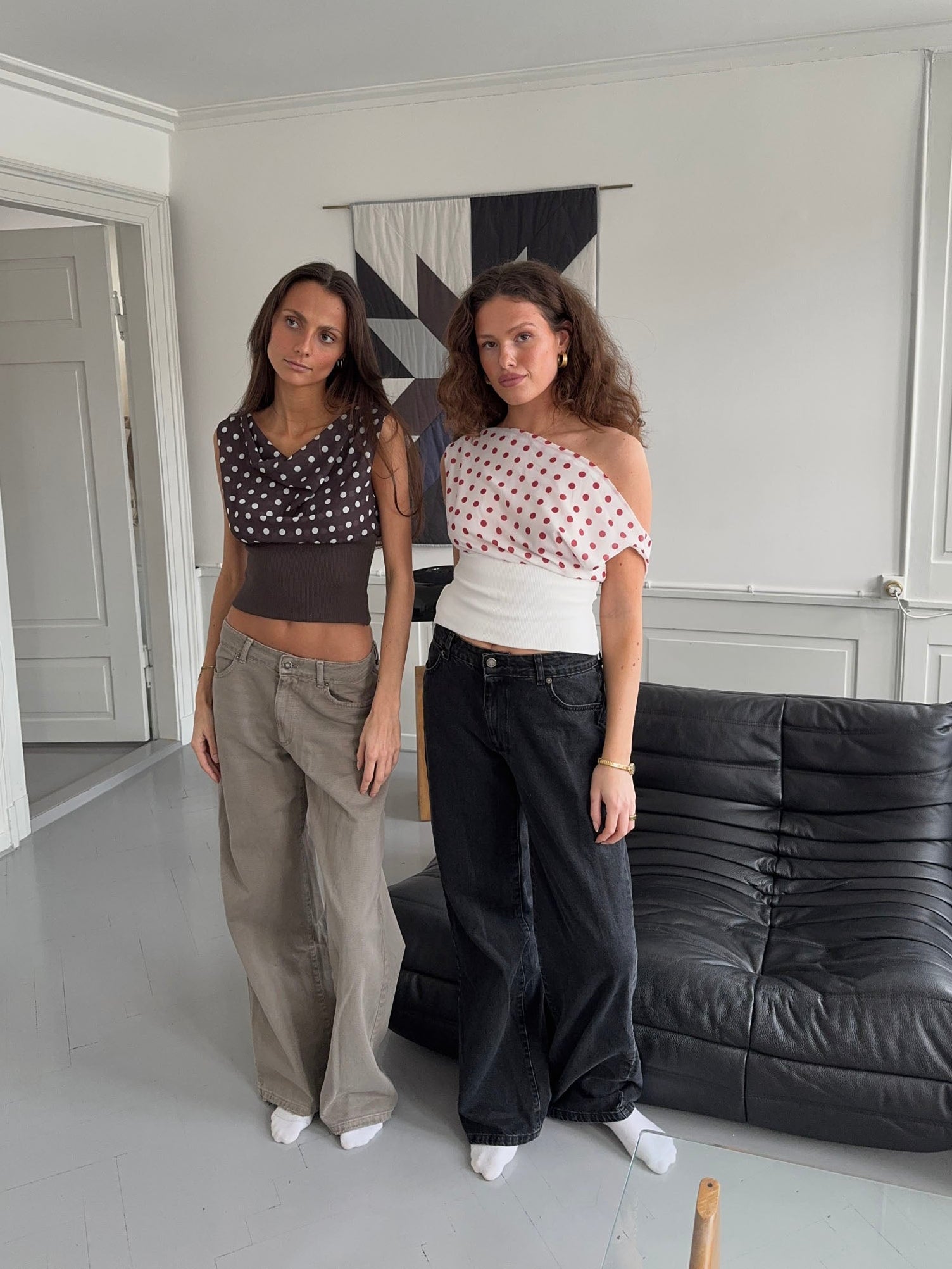 Two-piece styling showing red polka dot draped crop top in white and black denim options