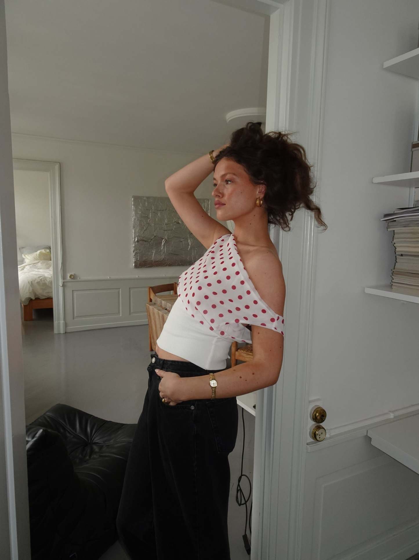 Red polka dot draped crop top with white ribbed band, side view
