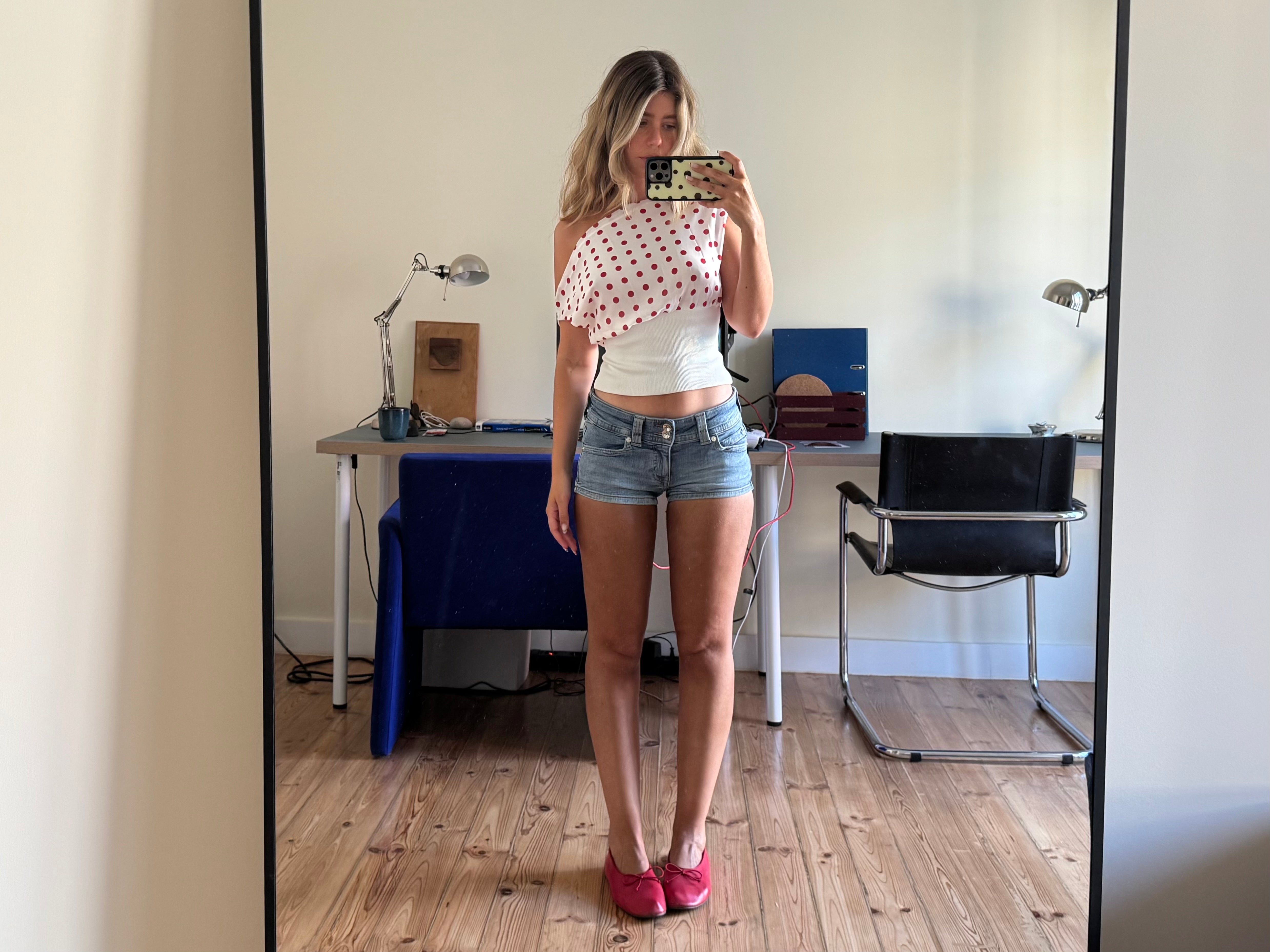 Draped polka dot crop top with white band, front mirror selfie