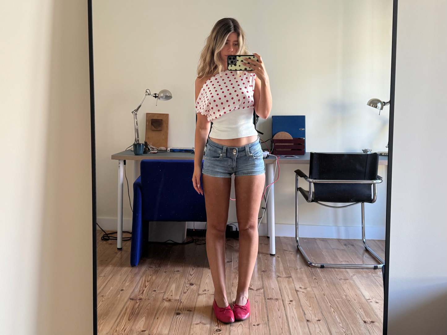 Draped polka dot crop top with white band, front mirror selfie