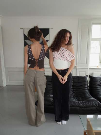 Red polka dot crop top with white ribbed waist and draped overlay