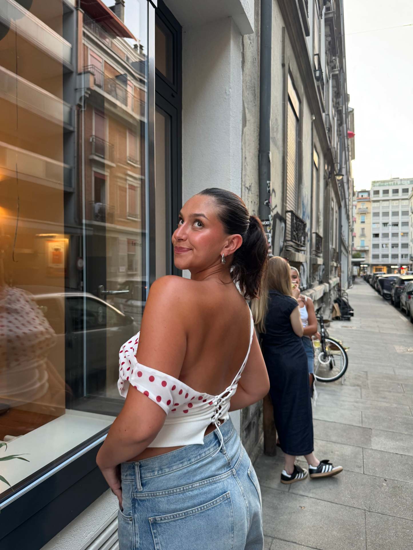Red polka dot crop top with off-shoulder drape and white trim detail