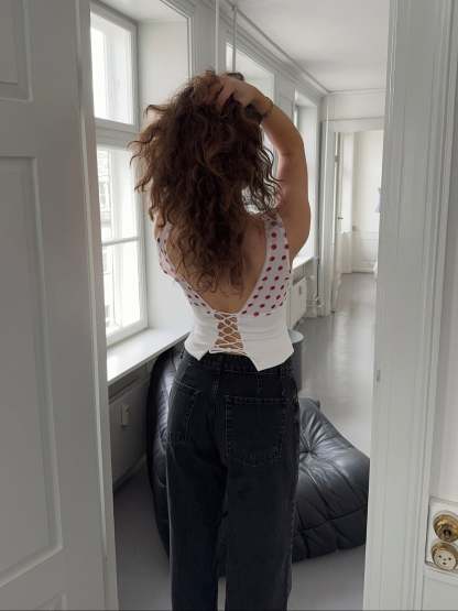 Red polka dot draped crop top with white ribbed trim and off-shoulder design