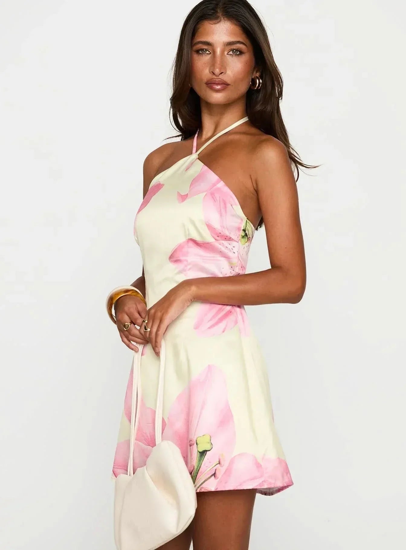 Side view of cream floral mini dress showing fitted bodice and above-knee hemline