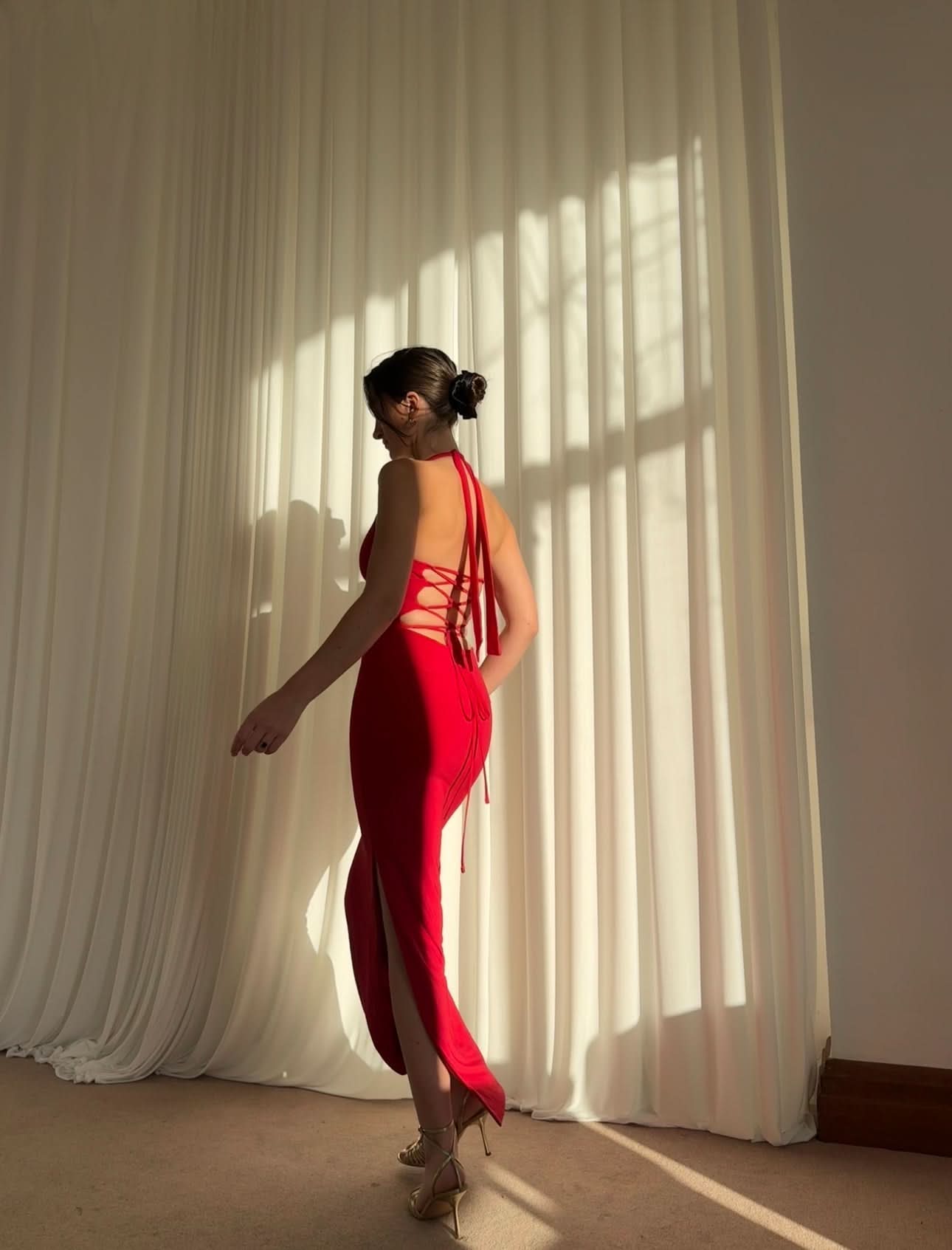 Red halter maxi dress with lace-up back detail and asymmetrical hem