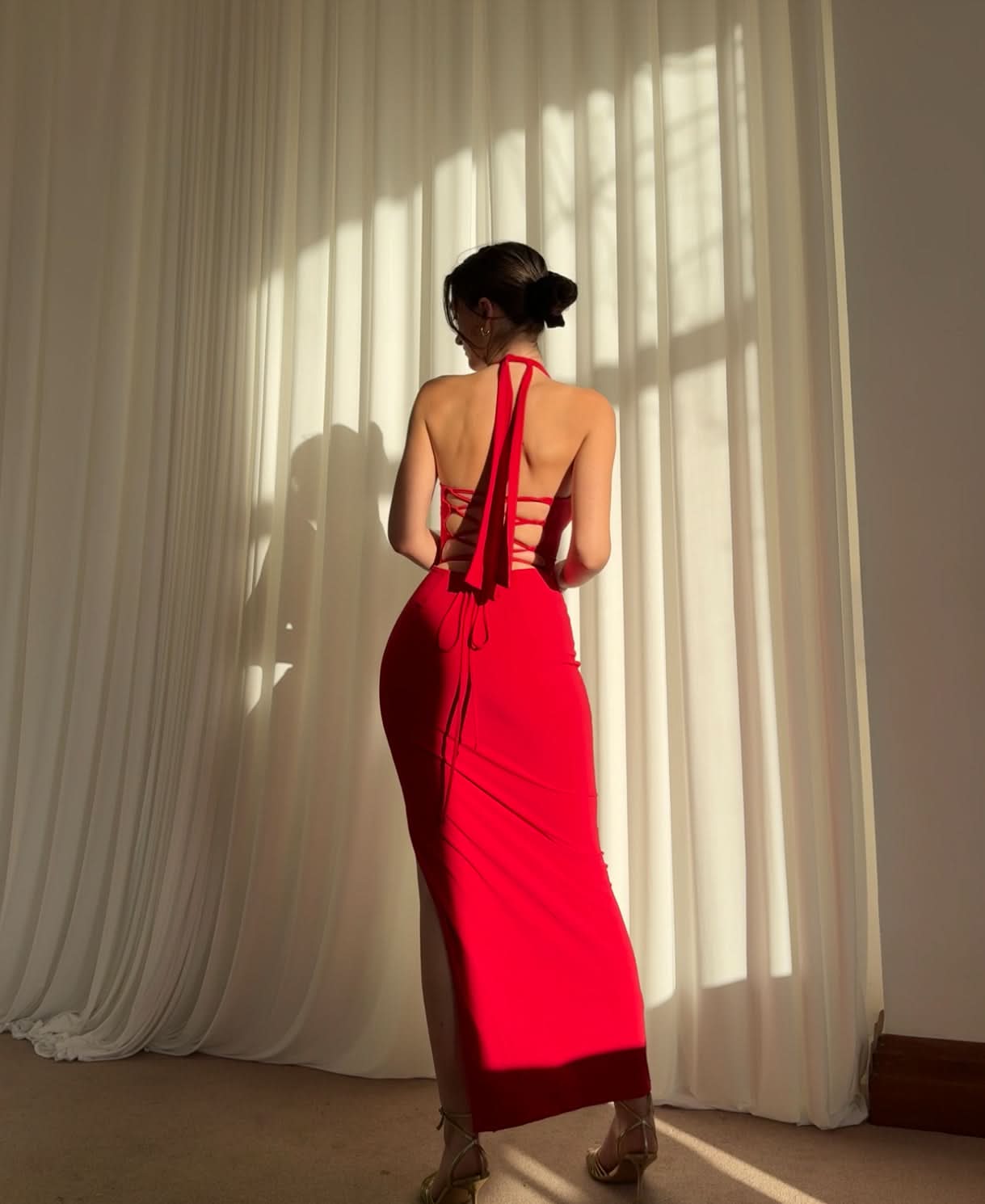 Red halter maxi dress back view showing lace-up straps