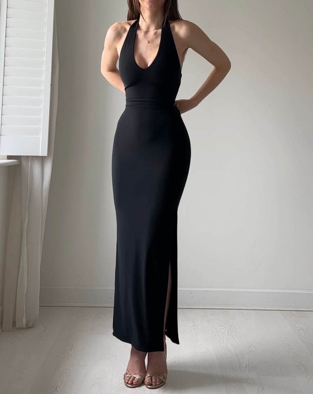 Black halter maxi dress with cinched waist and side slit
