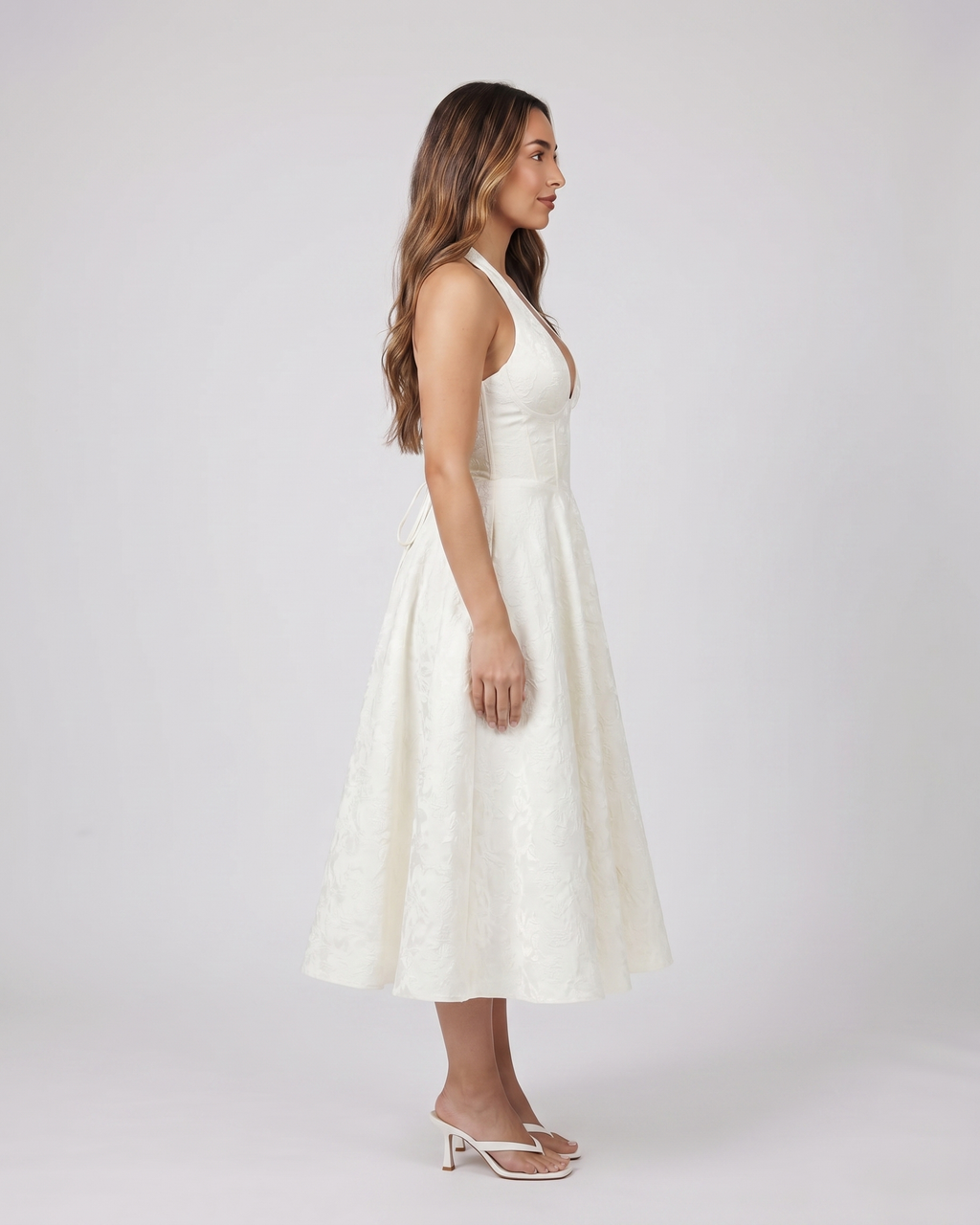 Side view of ivory floral jacquard halter midi dress