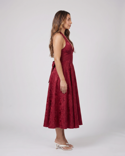 Side view of red floral jacquard halter midi dress