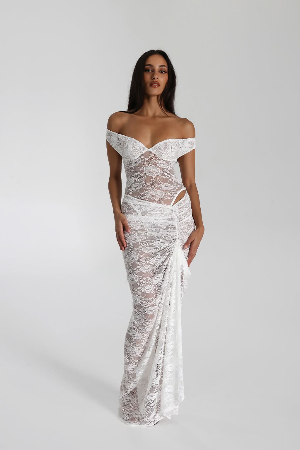 White lace maxi dress with draped off-shoulder design and sheer lace overlay