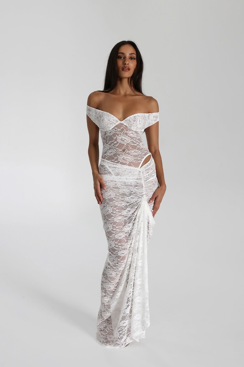 White lace maxi dress with draped off-shoulder design and sheer lace overlay