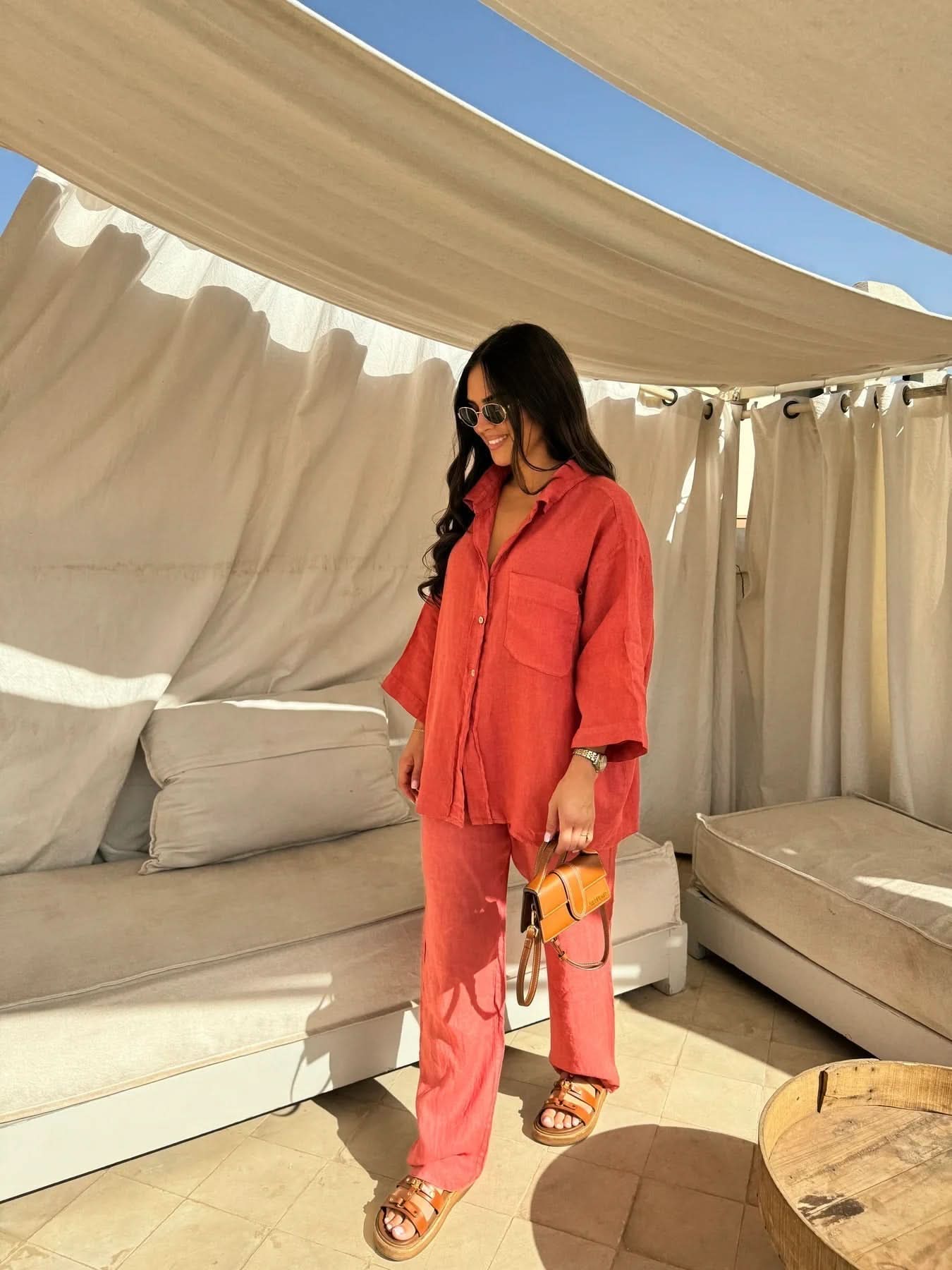 Coral red linen button-up shirt and relaxed pants ensemble