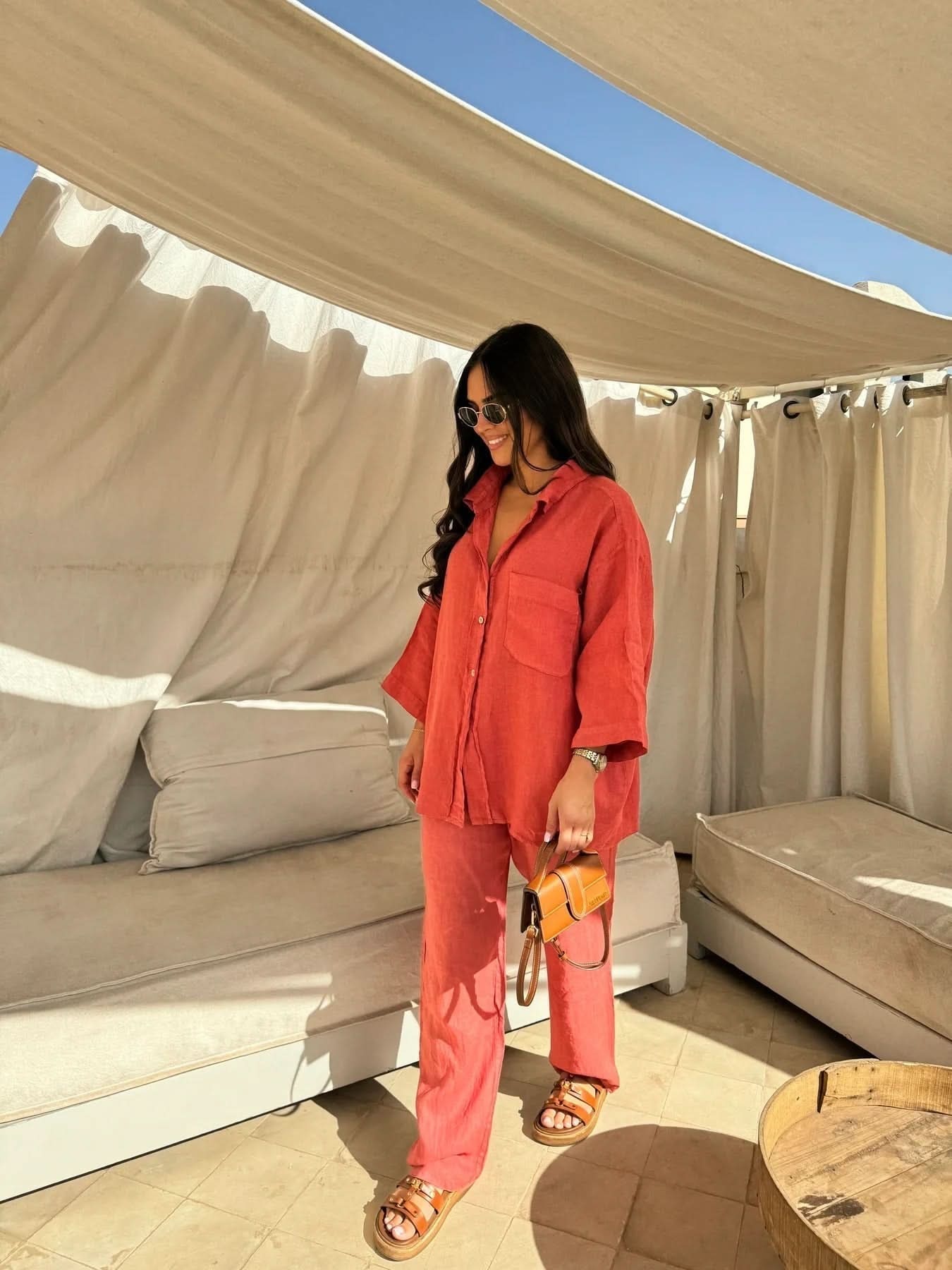 Coral red linen button-up shirt and relaxed pants ensemble
