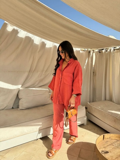 Coral red linen button-up shirt and relaxed pants ensemble