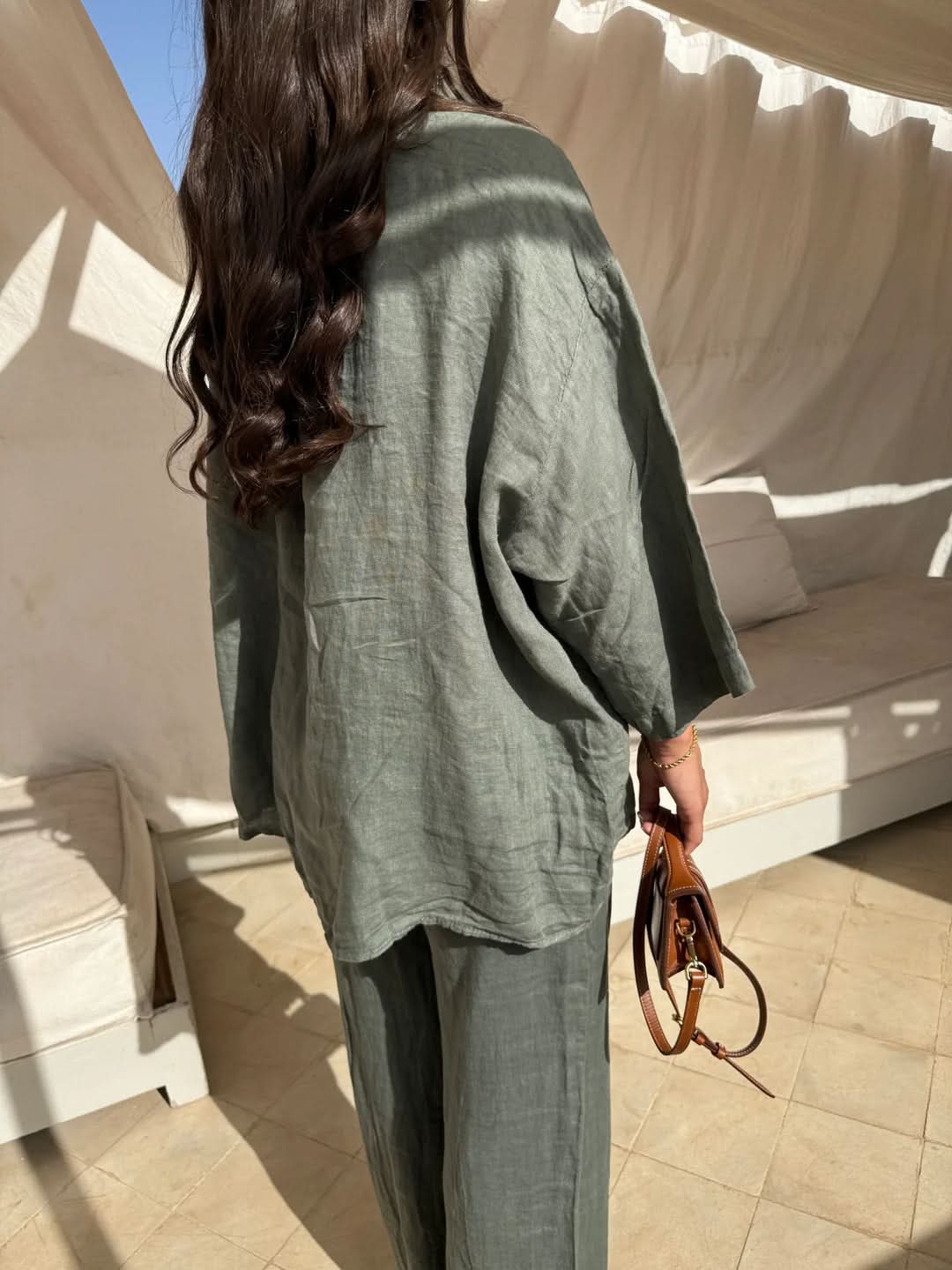 Sage green linen shirt close-up showing collar and button front