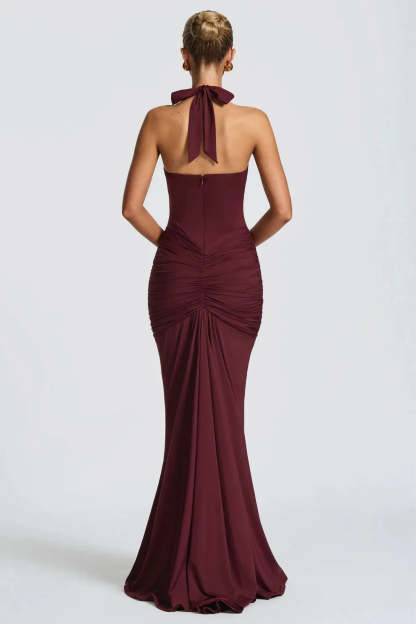 Back view of burgundy ruched maxi dress with halter tie and mermaid hem