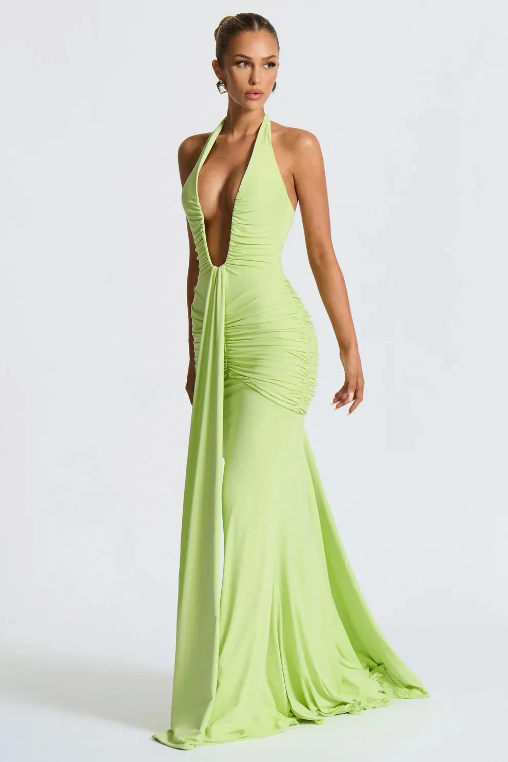Lime green halter ruched maxi dress with deep V-neckline and flowing train