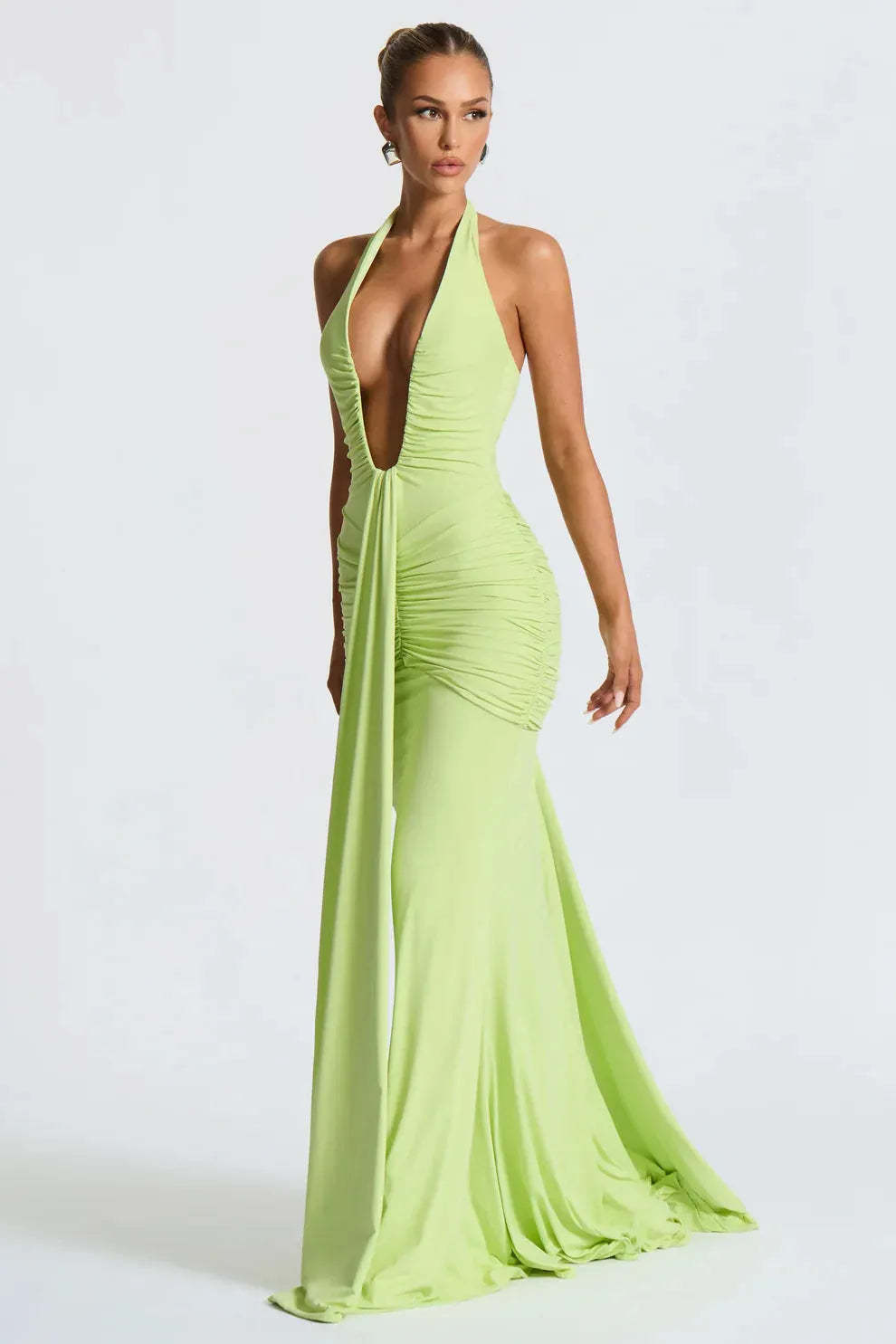 Lime green halter ruched maxi dress with deep V-neckline and flowing train