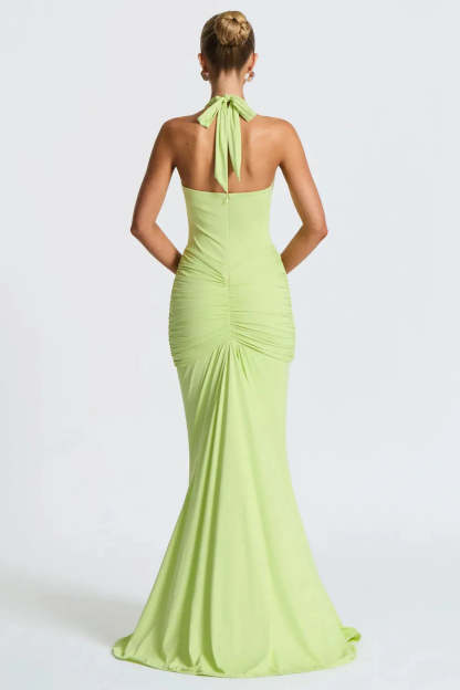 Back view of lime green halter ruched maxi dress with tied neckline and fitted silhouette