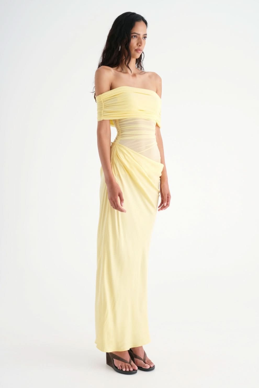 Side view of yellow ruched maxi dress with off-shoulder neckline