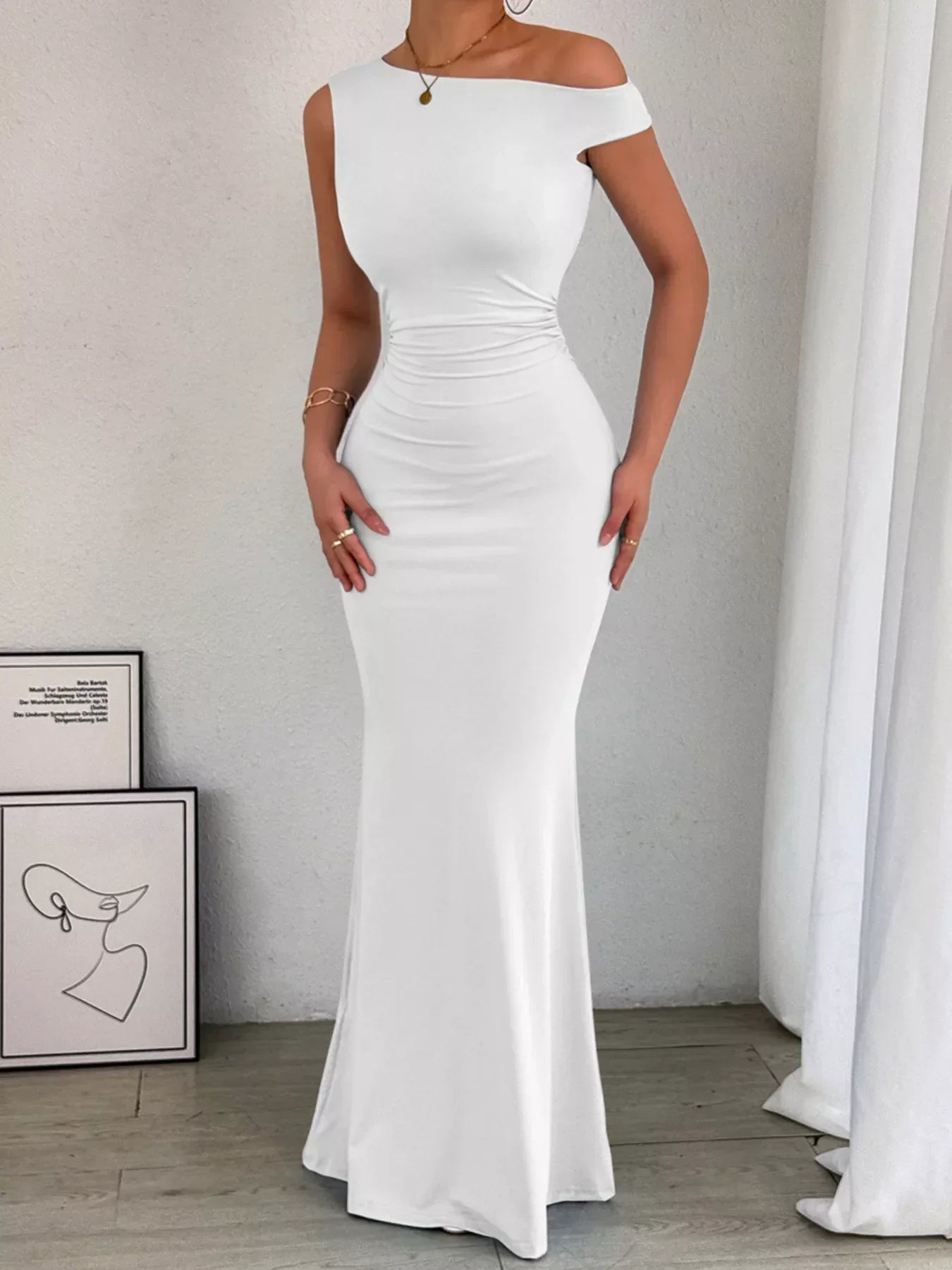 Back view of navy maxi dress showing ruched side seams and sleeveless cut