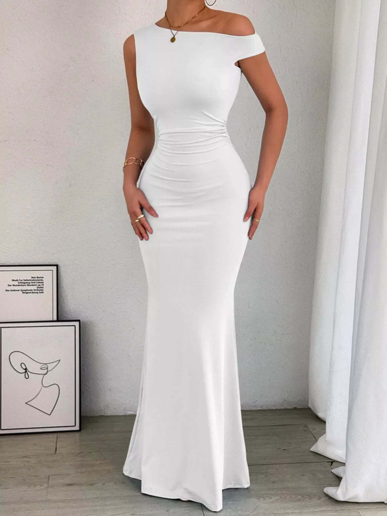 Back view of navy maxi dress showing ruched side seams and sleeveless cut