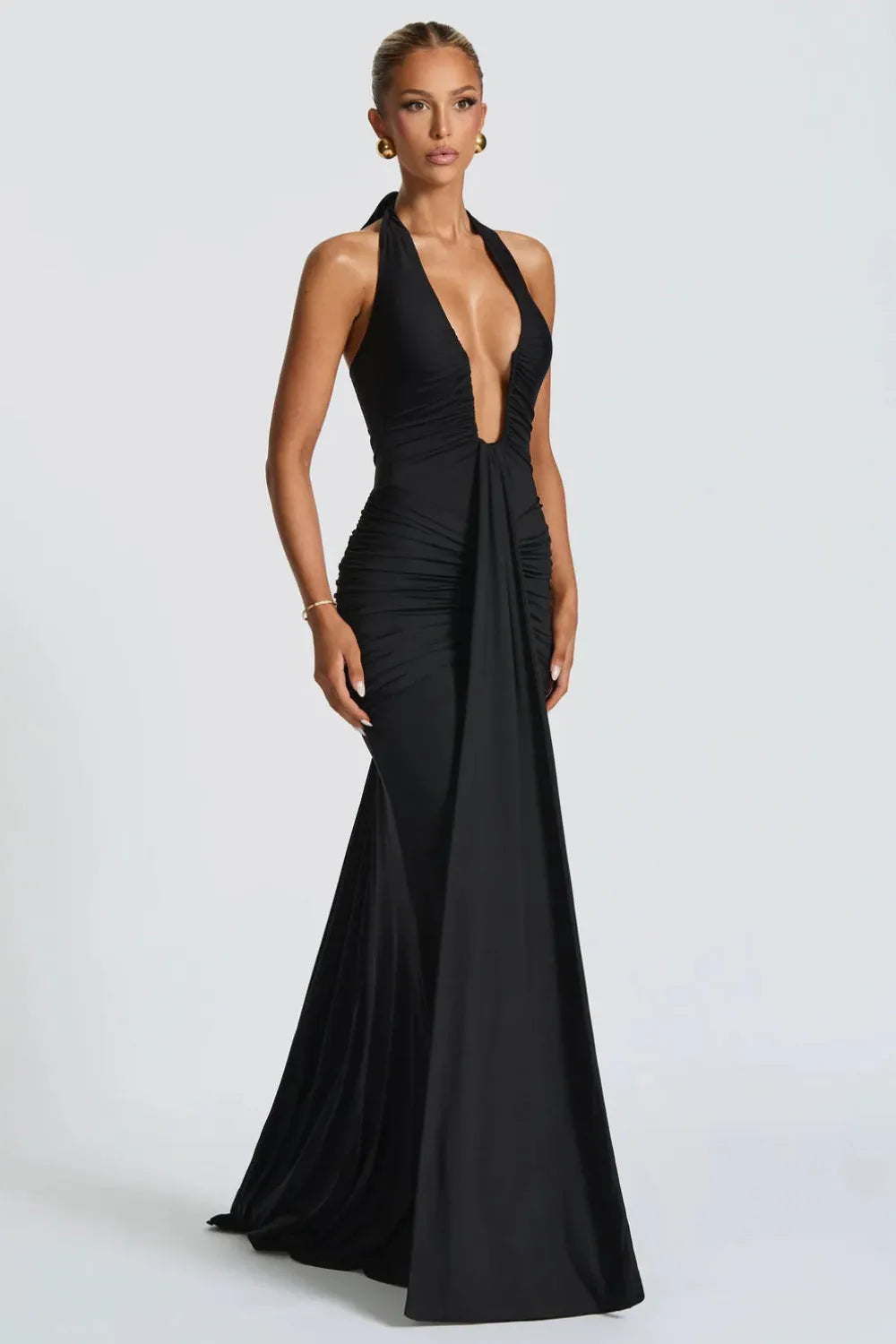 Black halter ruched maxi dress with plunging neckline and flowing train