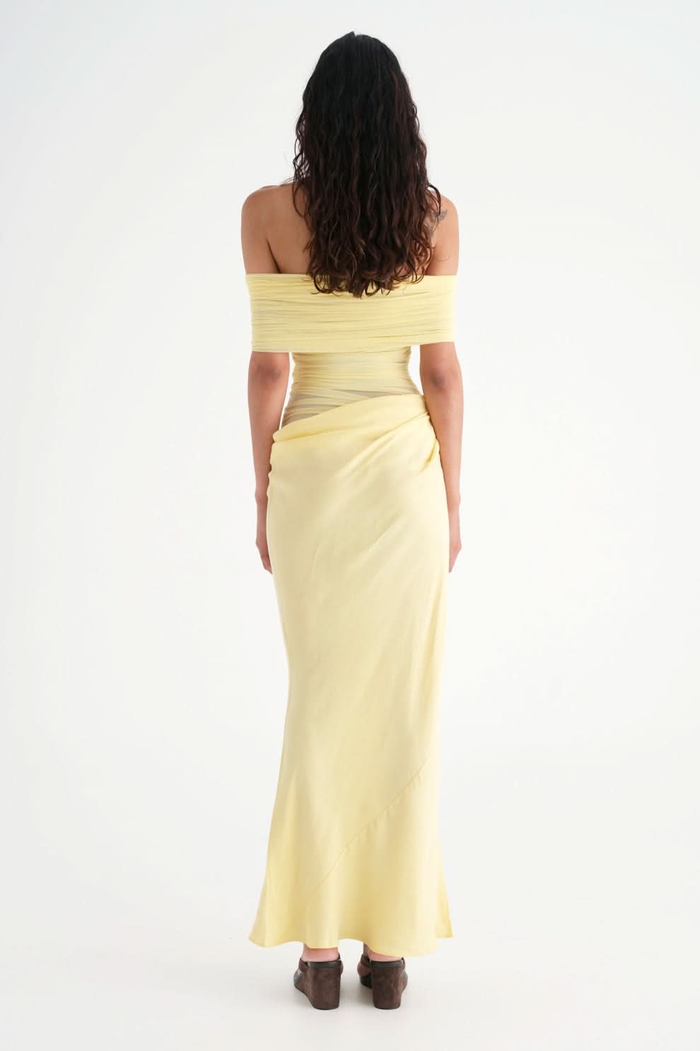 Back view of yellow ruched maxi dress with draped skirt