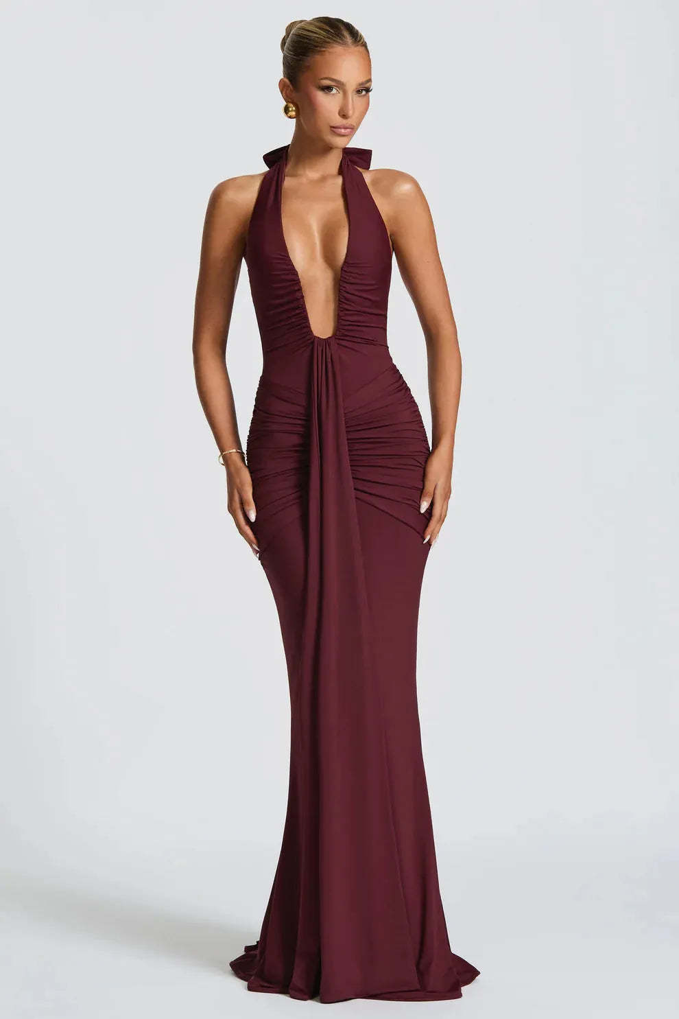 Burgundy halter ruched maxi dress with plunging neckline and mermaid silhouette