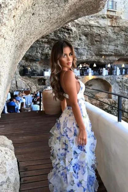 Back view of blue floral maxi dress showing open back design and cascading ruffles