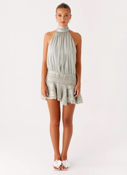 Sage green pleated halter mini dress with ruffle hem and high neckline