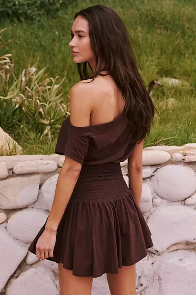Back view of brown ruffle mini dress showing off-shoulder neckline