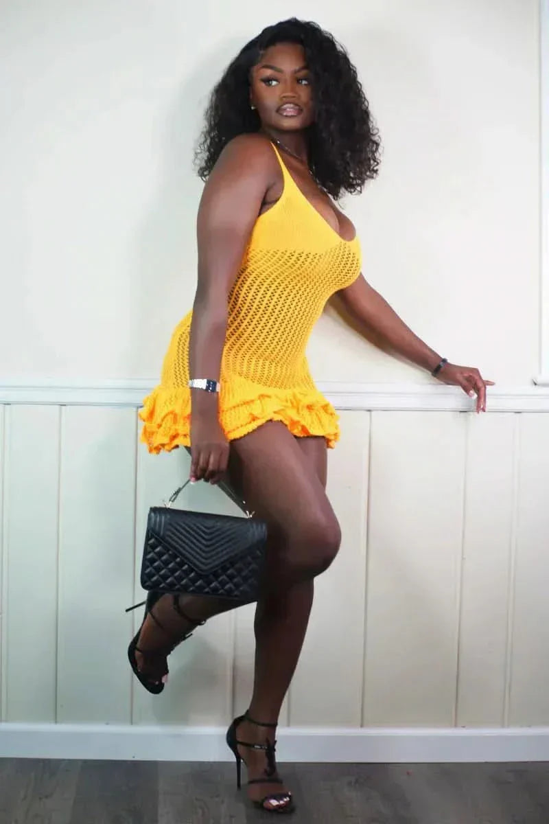 Side view of yellow mesh mini dress with ruffled hem detail