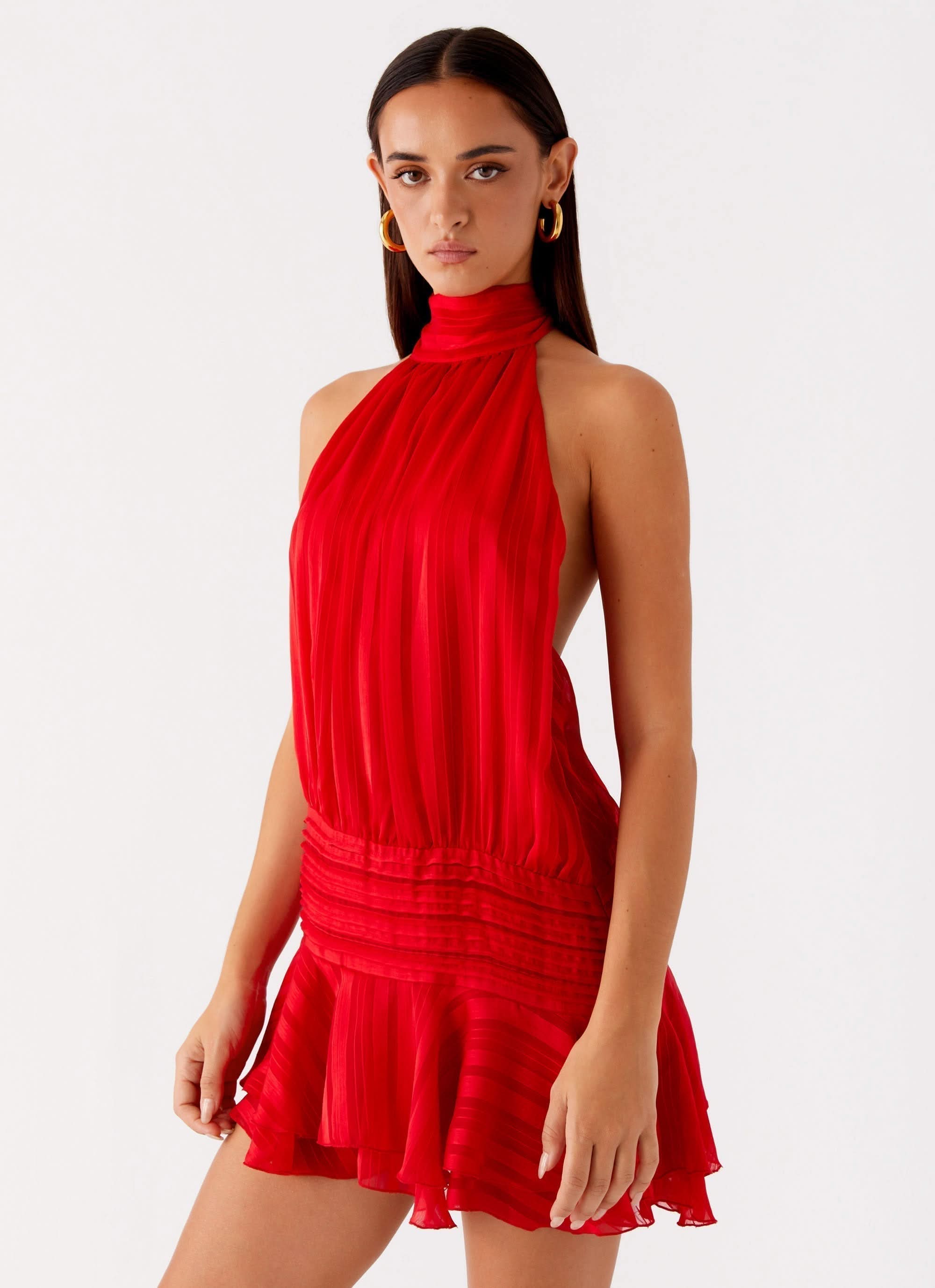 Bright red pleated halter mini dress with cinched waist and tiered ruffle skirt