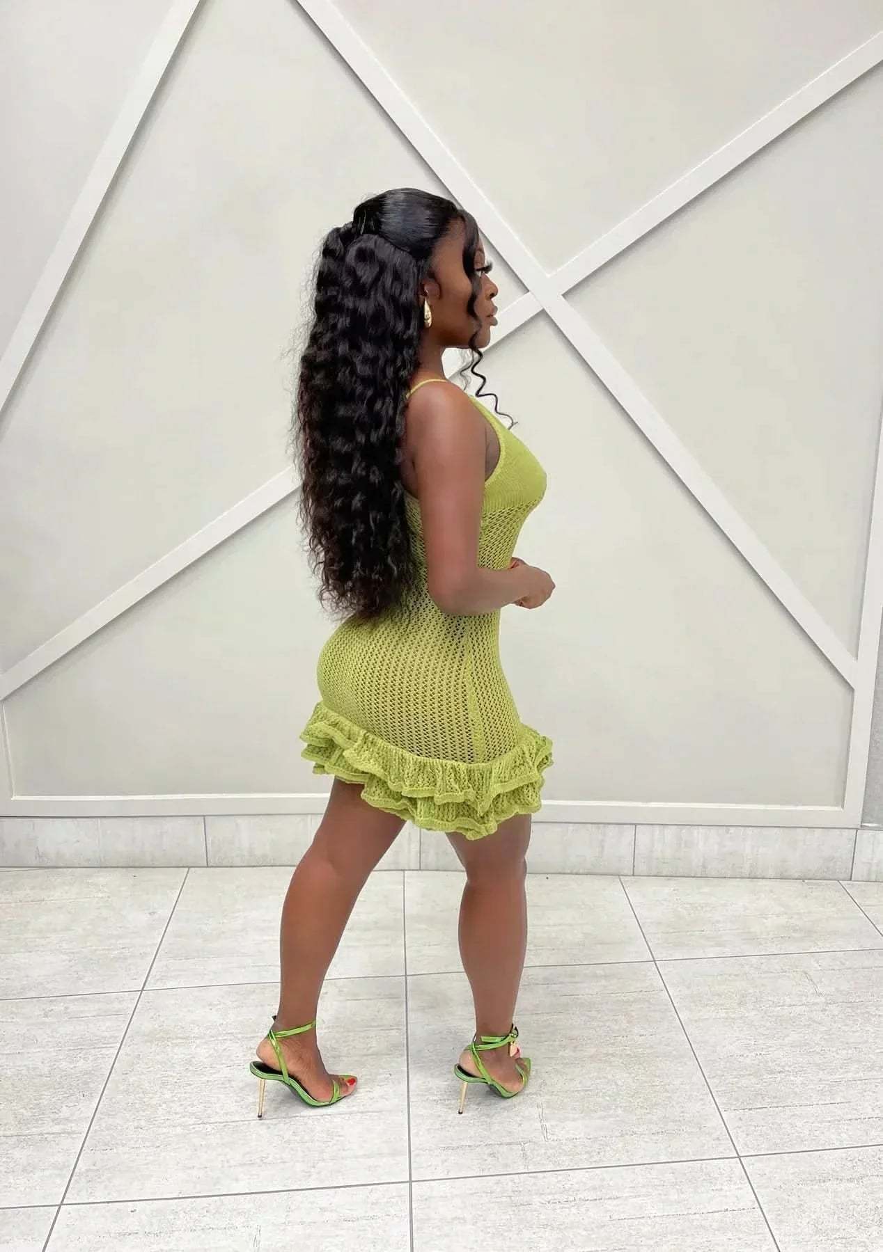 Side profile of lime green mesh mini dress with layered ruffle skirt