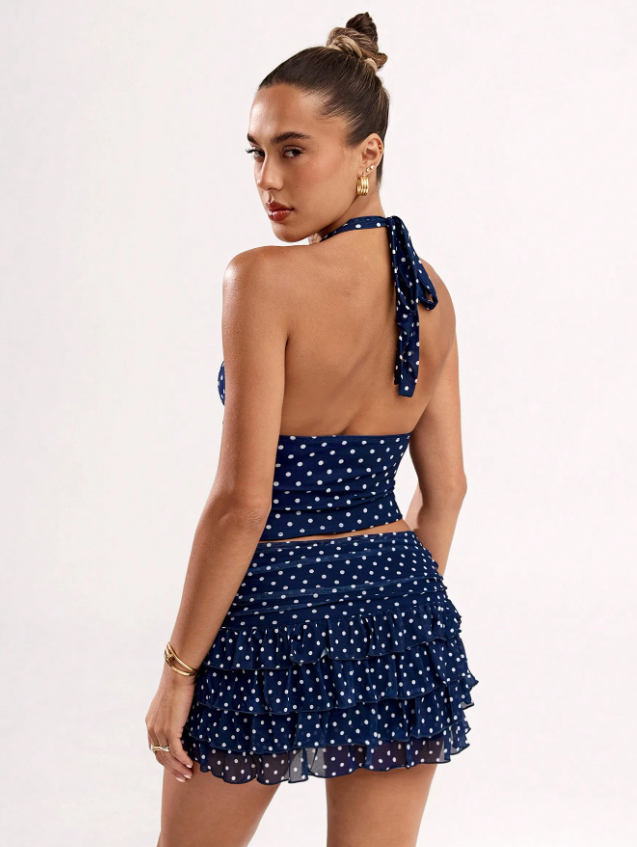 Open-back halter tie closure and layered ruffle mini skirt in navy polka dot print