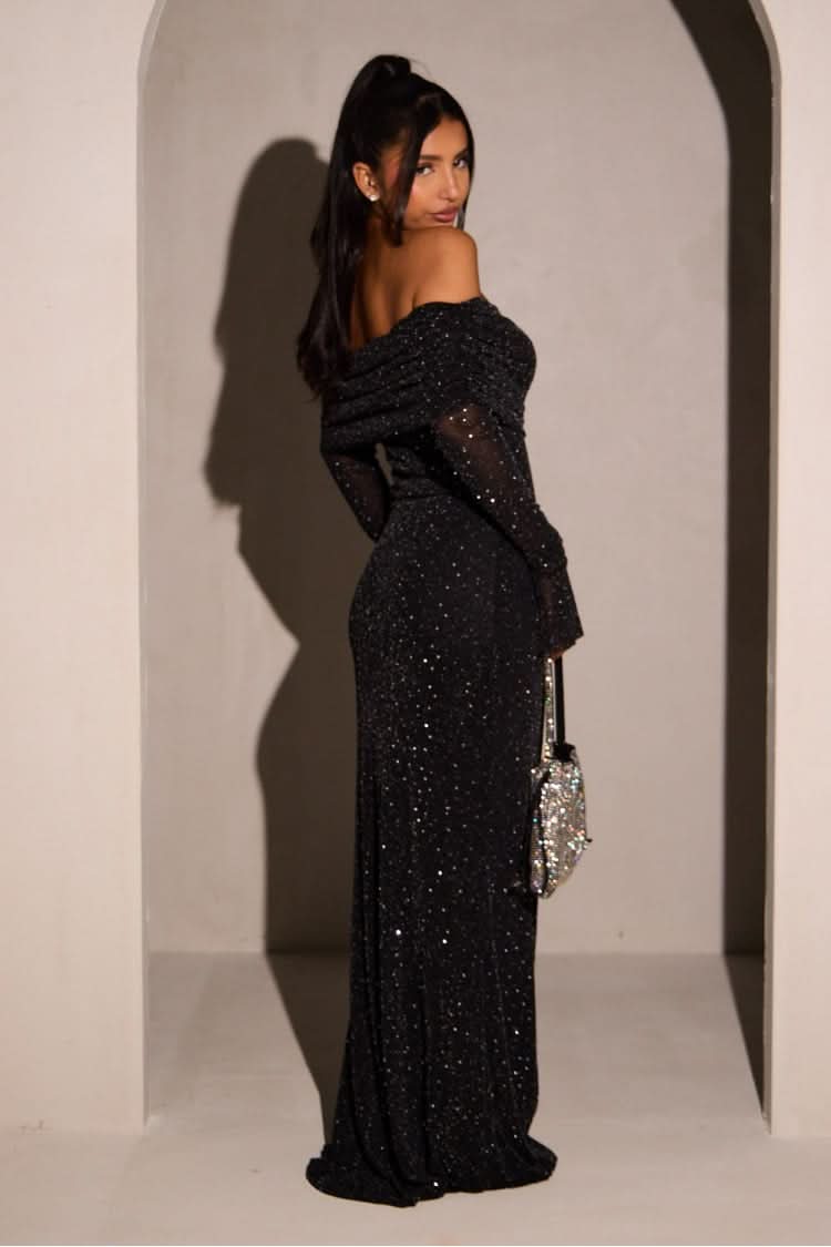Back view of black sequin maxi dress with off-shoulder design and long sleeves