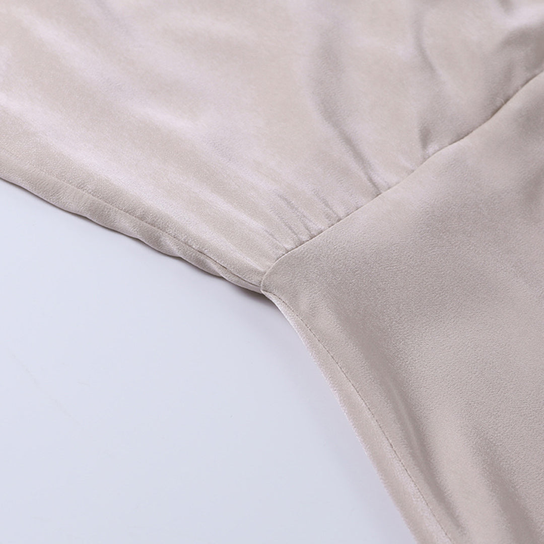 Beige wrap maxi dress fabric texture with soft draping detail