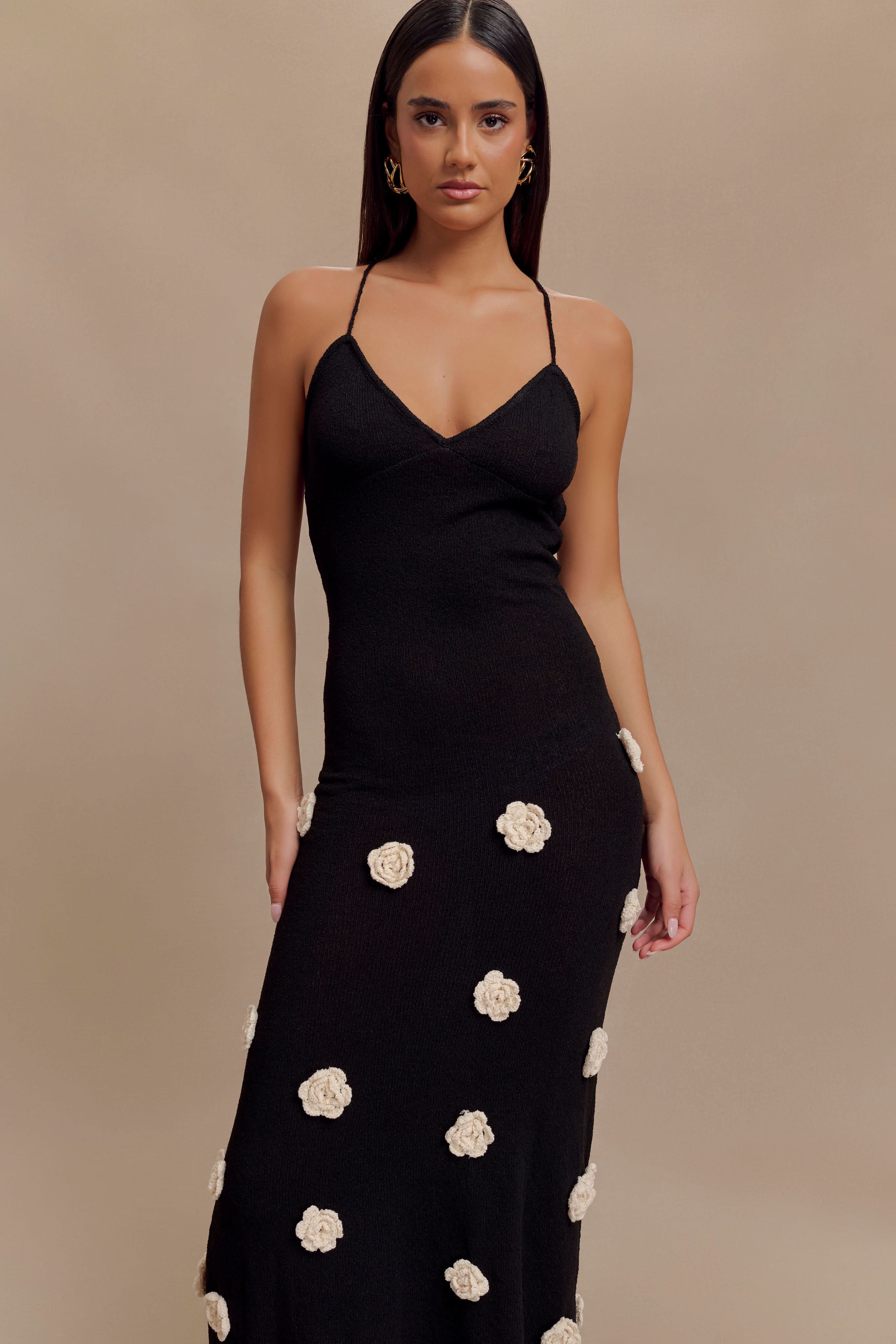 Black ribbed maxi dress with cream rose embellishments and v-neckline