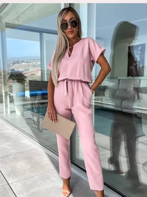 Pink keyhole wrap jumpsuit with short sleeves and drawstring waist