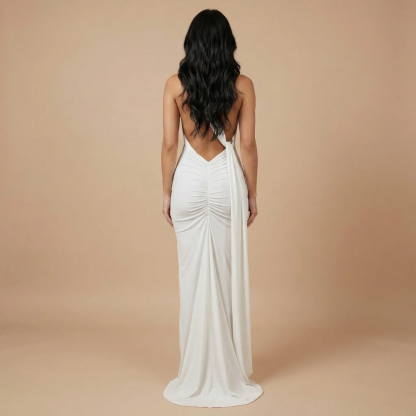 Back view of white draped maxi dress with plunging open back and flowing ruched fabric