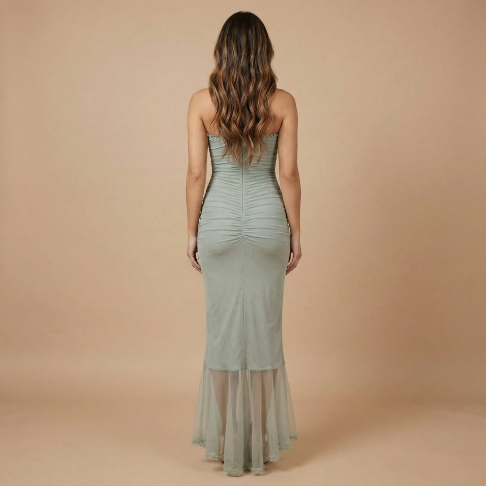 Back view of sage green ruched maxi dress showing sweetheart back and flowing ruffled hemline