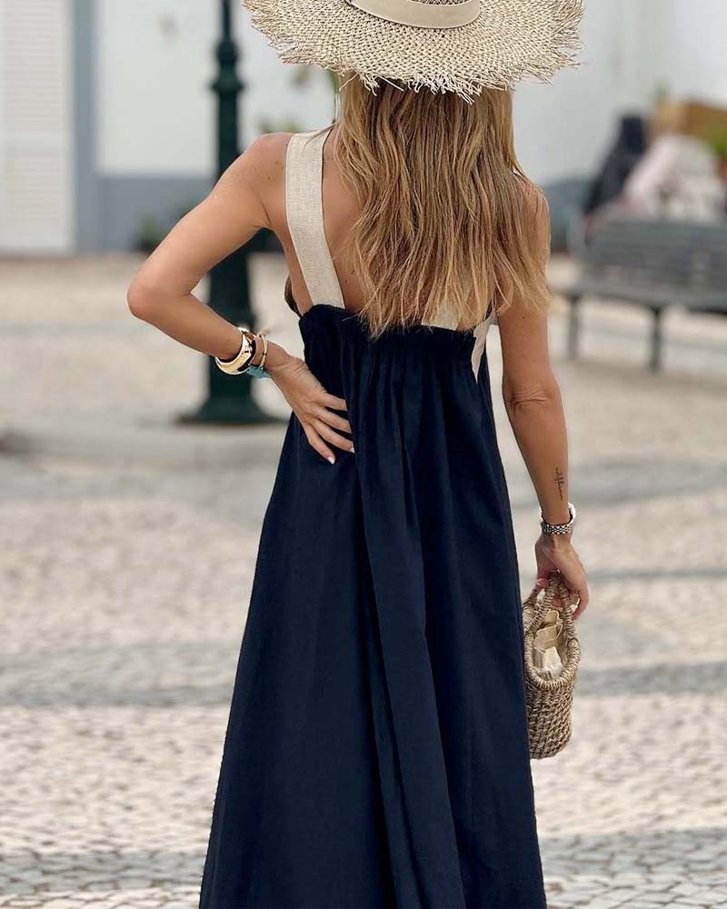 Back view of navy maxi dress showing cream cross-back straps